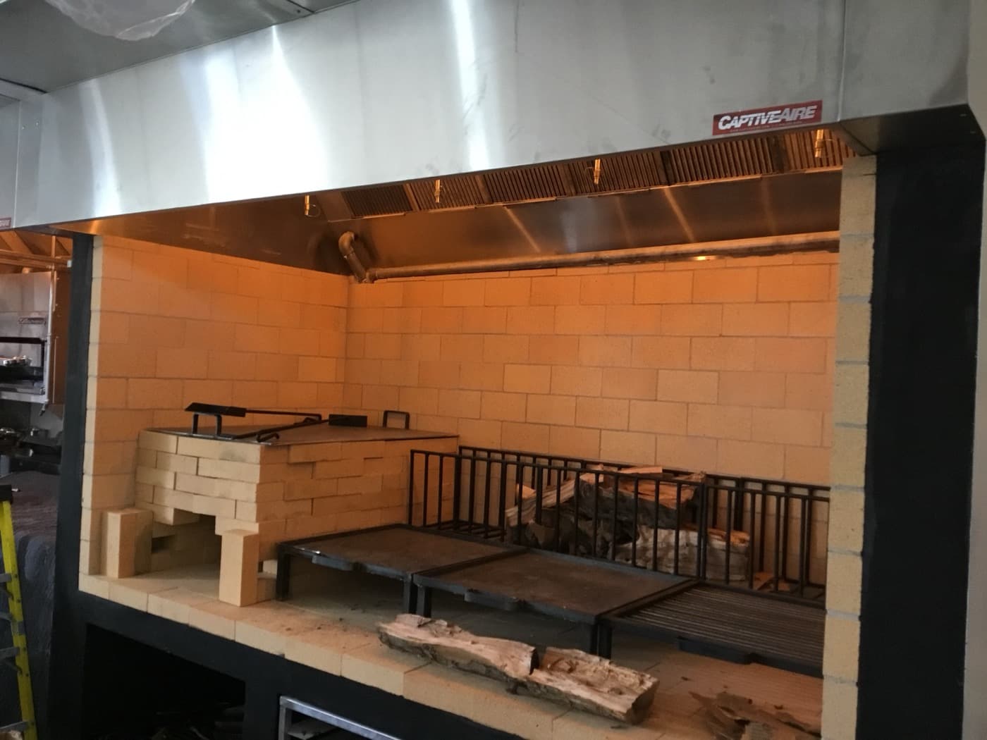 Custom brick BBQ pit with CaptiveAire exhaust hood — specialty ventilation install