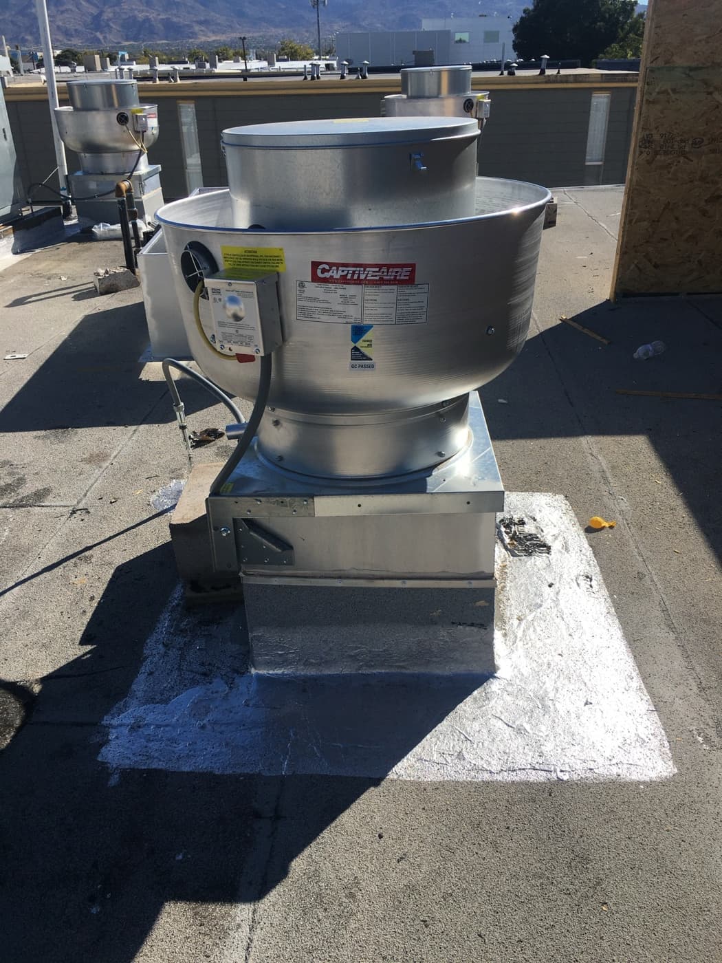 Commercial kitchen upblast exhaust fan on a rooftop